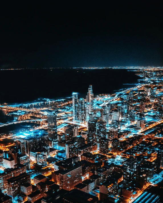 an aerial view of a city at night, a colorized photo, by Ryan Pancoast, unsplash contest winner, happening, beautiful blue lights, chicago skyline, background image