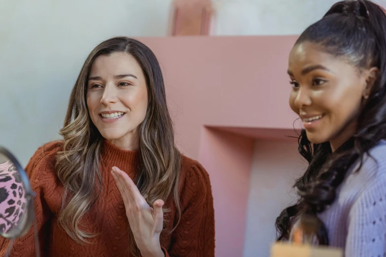 a couple of women standing next to each other, trending on pexels, hailee steinfeld, giving an interview, with brown skin, product introduction photo