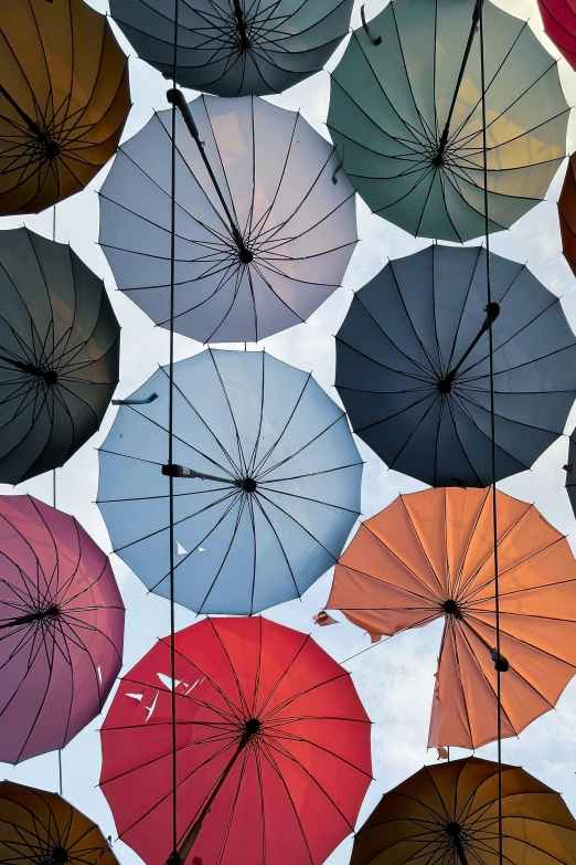 a bunch of umbrellas hanging from the ceiling, an album cover, inspired by Ai Weiwei, trending on unsplash, color”, square, charts, conde nast traveler photo