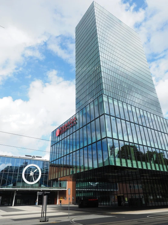 a tall glass building sitting on the side of a road, norrlandsskog, thumbnail, capital plaza, low quality photo