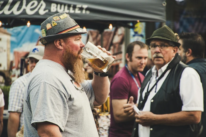 a man with a long beard drinking a beer, pexels contest winner, festival, avatar image, bulli, people watching around