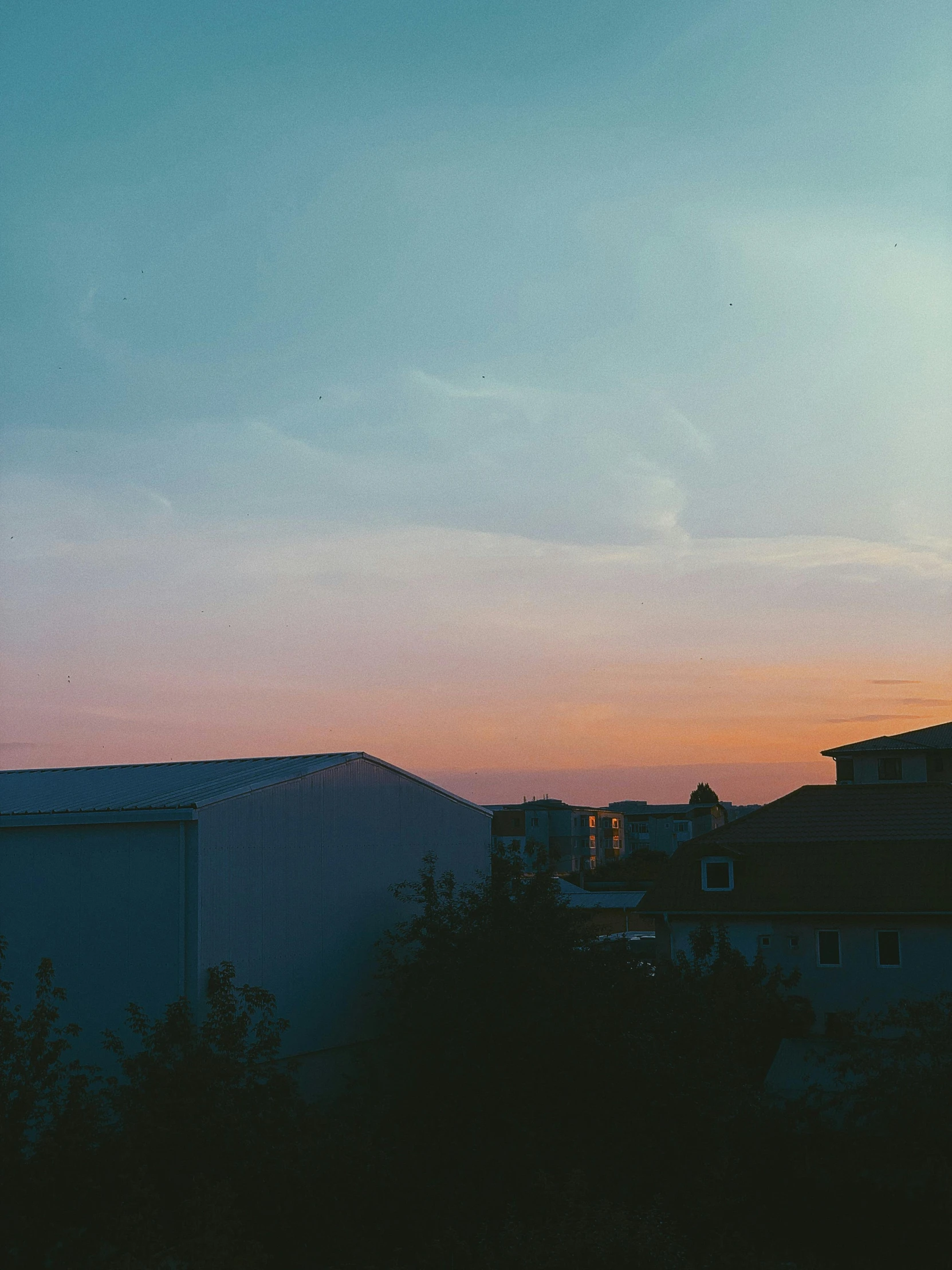 a clock tower sitting on the side of a building, a picture, inspired by Elsa Bleda, unsplash contest winner, aestheticism, sunset panorama, trending on vsco, vhs colour photography, humid evening