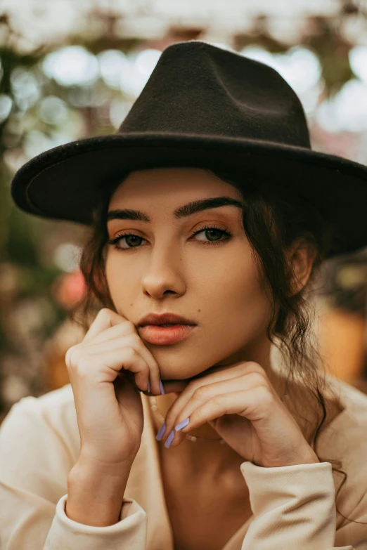 a beautiful young woman wearing a black hat, a colorized photo, trending on pexels, angular eyebrows, pokimane, square face, 5 0 0 px models