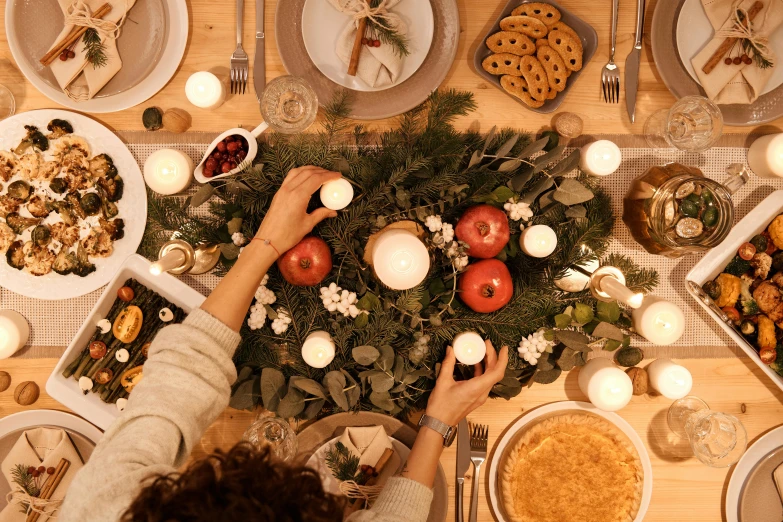 a table topped with plates of food and candles, by Emma Andijewska, pexels contest winner, wearing festive clothing, background image, flat lay, reverse