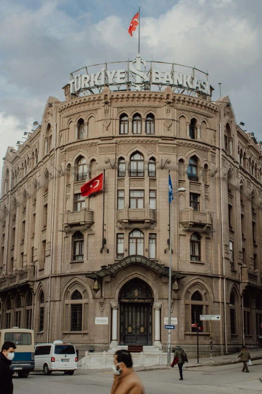 a group of people crossing a street in front of a building, inspired by Osman Hamdi Bey, pexels contest winner, art nouveau, turkey, 2 5 6 x 2 5 6 pixels, panorama view, freddy mamani silvestre facade