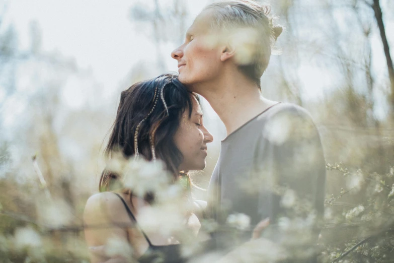 a man and a woman standing next to each other, unsplash, romanticism, the non-binary deity of spring, cuddling, manuka, profile image