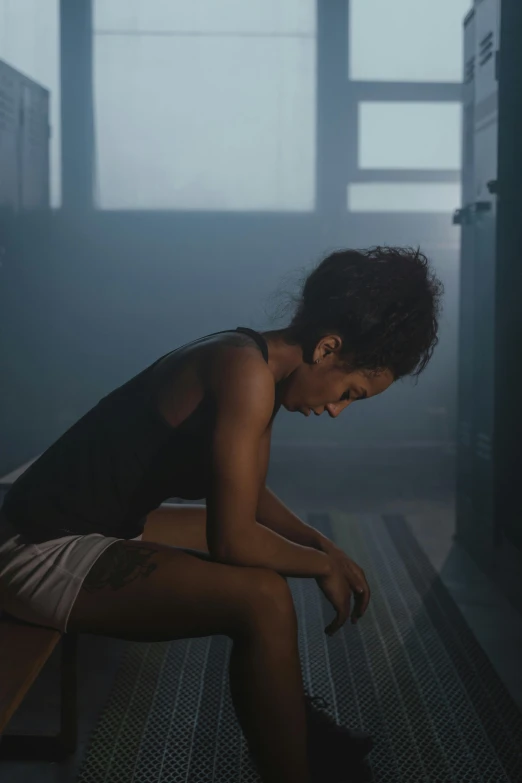 a woman sitting on a bench in a dark room, inspired by Nan Goldin, pexels contest winner, sweaty. steam in air, ashteroth, movie still of a tired, (mist)