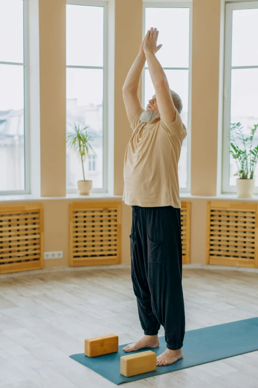 a man standing on a yoga mat in a room, pexels contest winner, renaissance, indistinct man with his hand up, profile image, old male, pixeled stretching