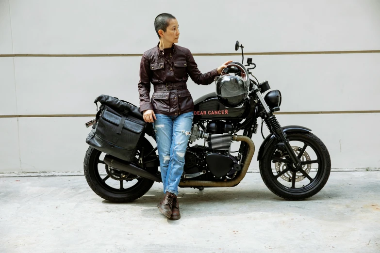 a man sitting on a motorcycle in front of a garage, with two front pockets, gemma chen, carrying a saddle bag, avatar image