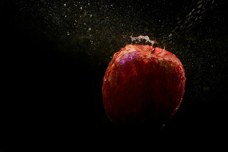 an apple is sprinkled with water on a black background, an album cover, by Tom Bonson, unsplash, fairy fruit. octane render, ignant, under a spotlight, 15081959 21121991 01012000 4k