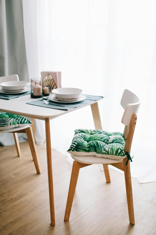 a dining room table and chairs in front of a window, unsplash, minimalism, cushions, green and white, jakarta, square