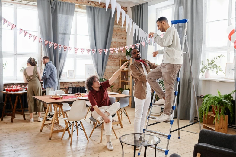 a group of people hanging bunting flags in a room, pexels contest winner, happening, ladders, sitting on top a table, parody work, fourth of july