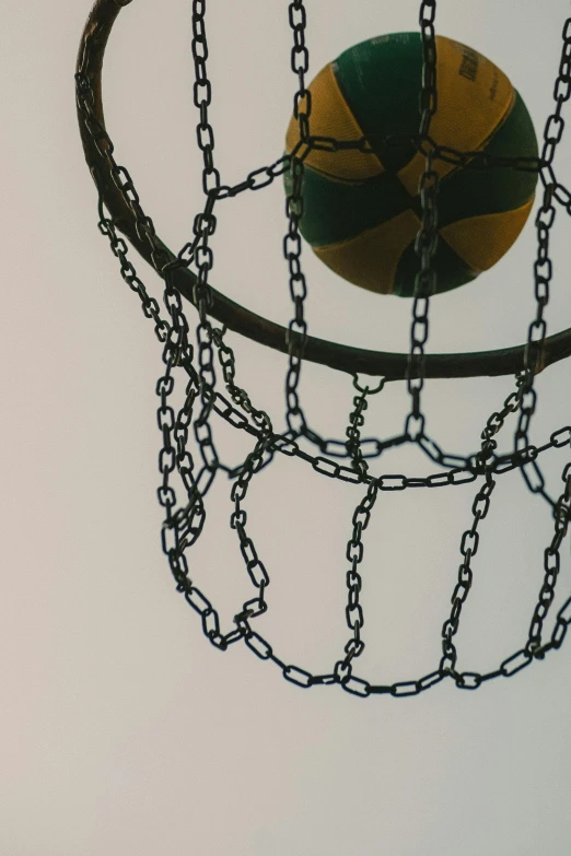 a basketball ball hanging from the rim of a basketball hoop, unsplash, conceptual art, ((chains)), ilustration, taken on iphone 14 pro, hoog detail