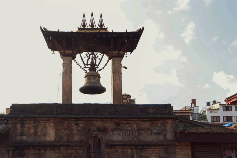 a bell that is on top of a building, an album cover, unsplash, renaissance, nepal, square, julia sarda, from of thrones