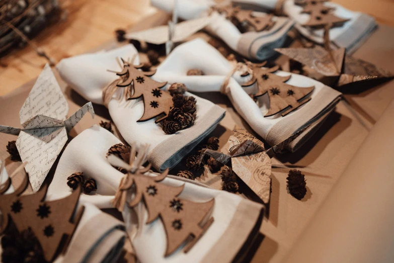 a bunch of napkins sitting on top of a table, by Emma Andijewska, pexels contest winner, wood ornaments, slippers, giving gifts to people, thumbnail