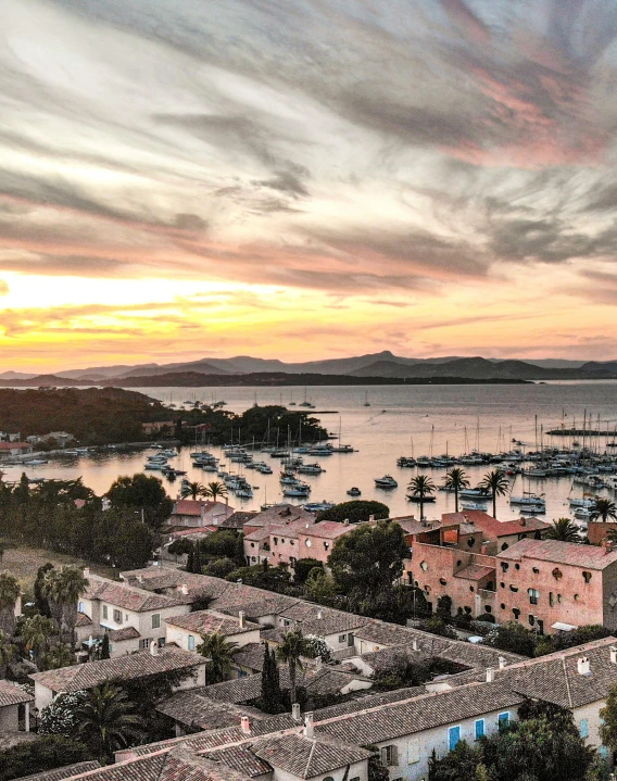 a harbor filled with lots of boats under a cloudy sky, inspired by Wilhelm Marstrand, pexels contest winner, pink marble building, high view, golden hour photograph, islands