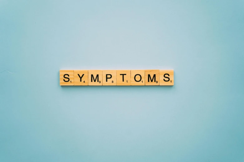 a scrabble spelling the word symptoms on a blue background, pexels, lots of signs, black mold, background image, sick with a cold