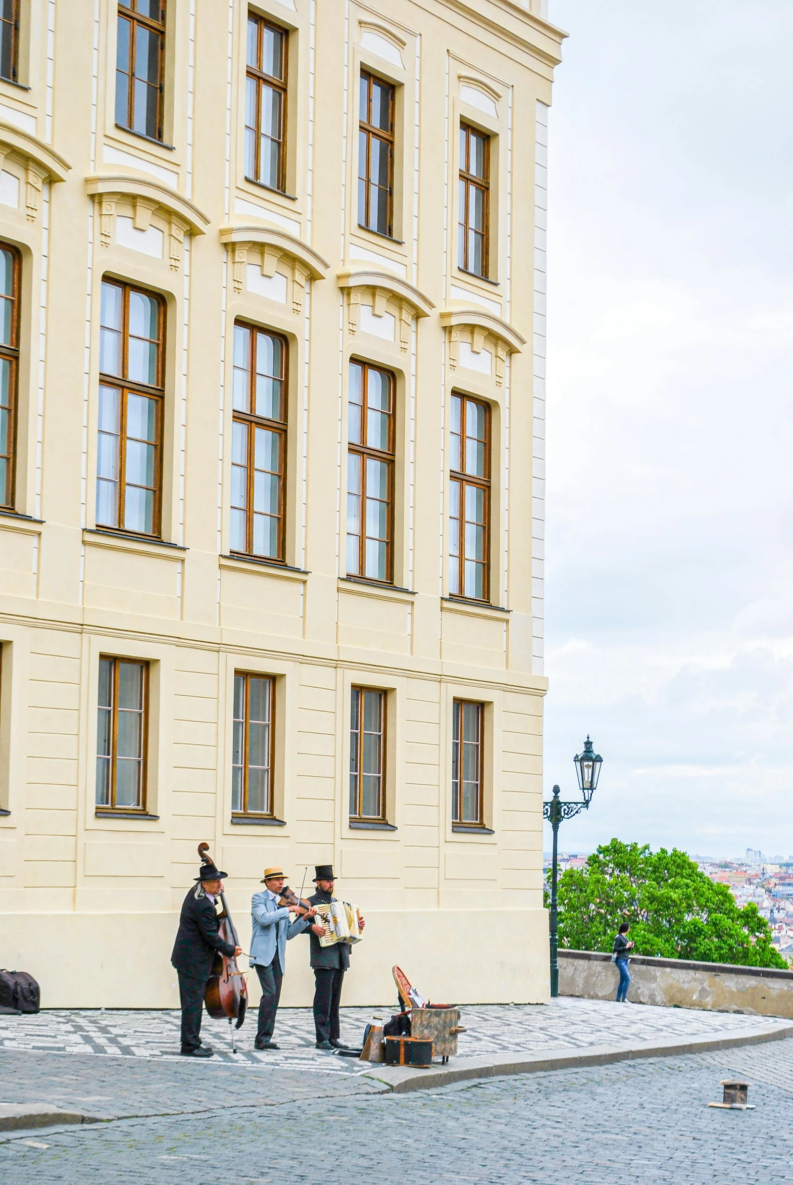 a group of people standing in front of a building, prague, looking off into the distance, helsinki, viking palace