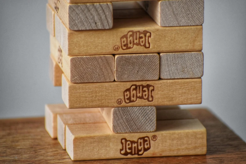 a stack of wooden blocks sitting on top of a table, ghutra and egal, detailed product image, viewed from the ground, lepra