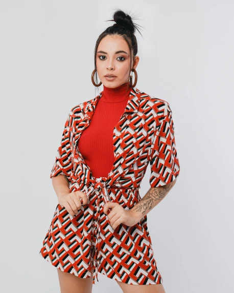 a woman in a red top and patterned shorts, by Julia Pishtar, trending on pexels, op art, wearing prison jumpsuit, open jacket, portrait of demi rose, 15081959 21121991 01012000 4k