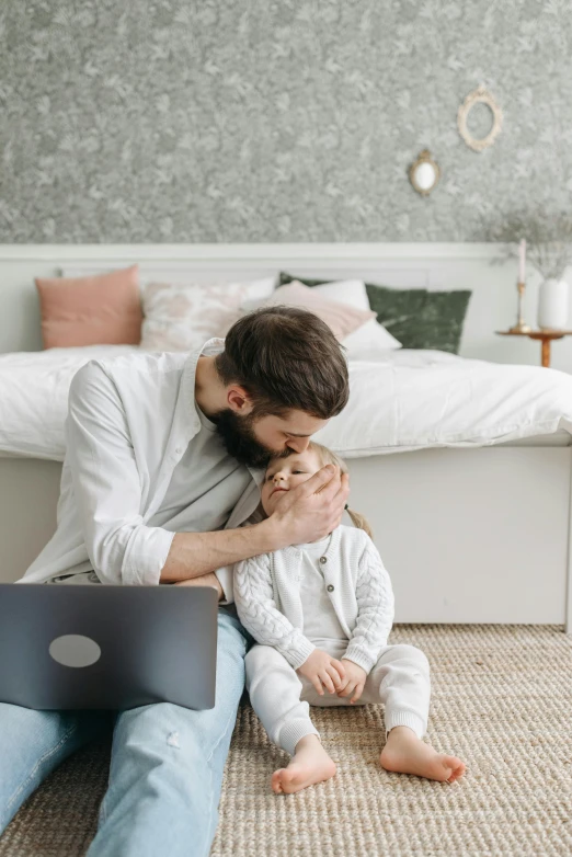 a man and a little girl sitting on the floor with a laptop, pexels contest winner, modernism, hugging, profile image, bearded, sitting in bedroom