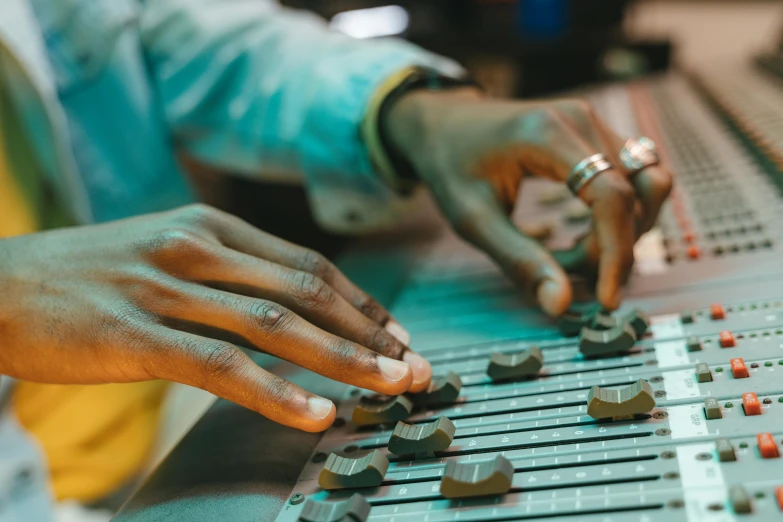 a close up of a person's hands on a mixing board, trending on pexels, process art, intricate african jewellery, mining, manufacturing, thumbnail