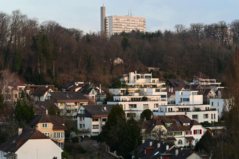 a view of a city from the top of a hill, by Breyten Breytenbach, flickr, modernism, photo of zurich, mass housing, seen from a distance, photographed for reuters