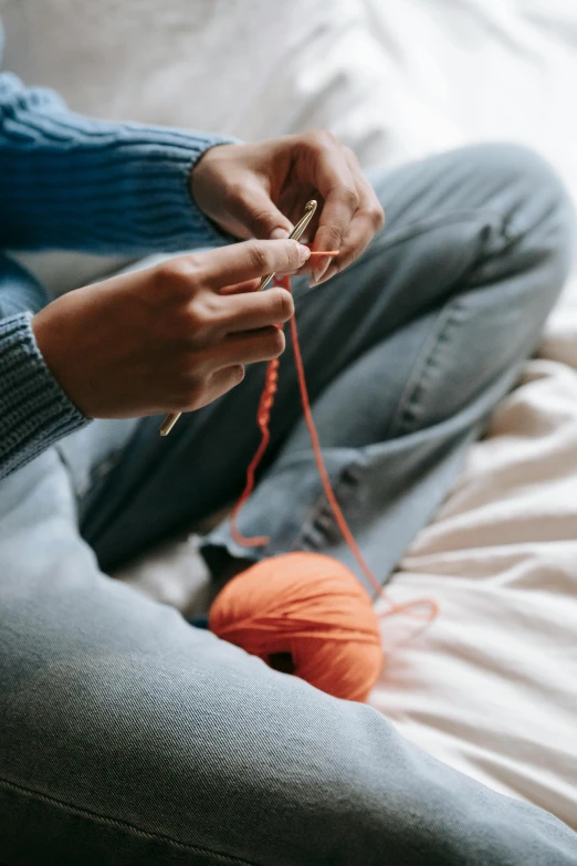 a person sitting on a bed with a ball of yarn, trending on pexels, stitching, thumbnail, inspect in inventory image, made of wool