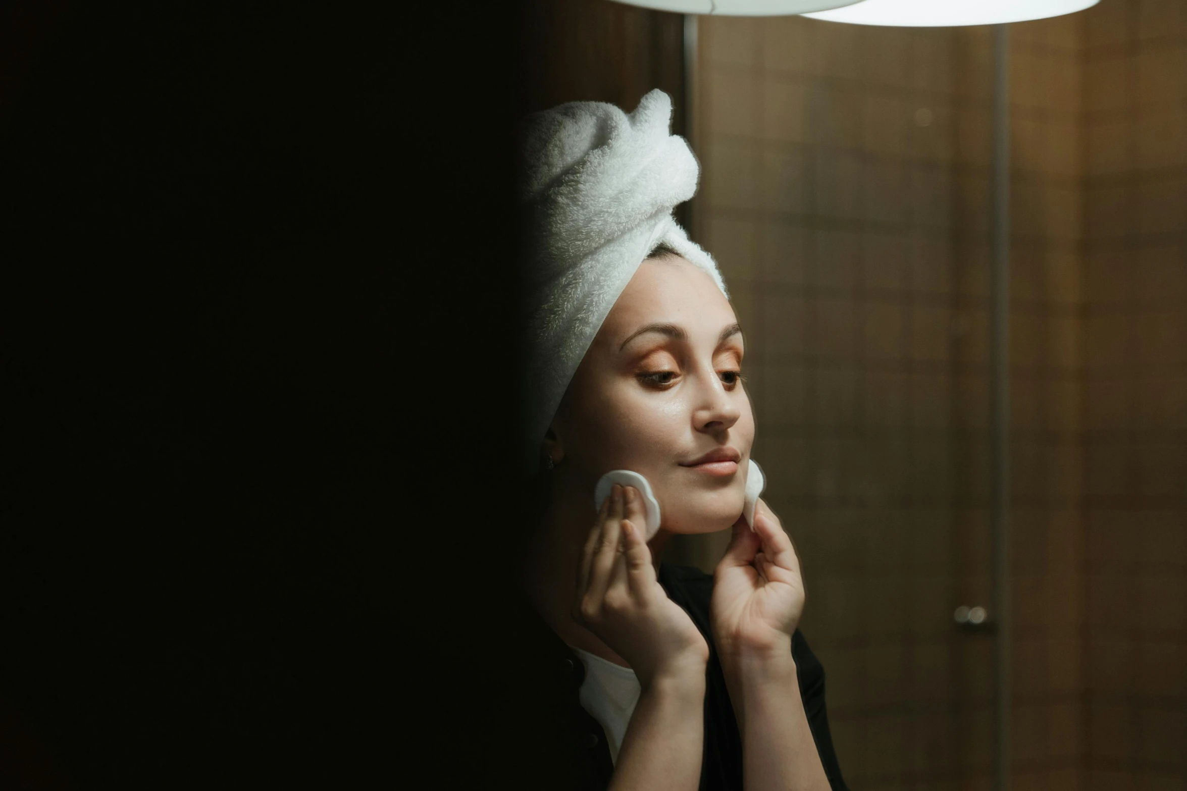 a woman with a towel on her head shaving her face, pexels contest winner, low lighting, her face in discs, girl with a pearl earringl, photoshoot for skincare brand