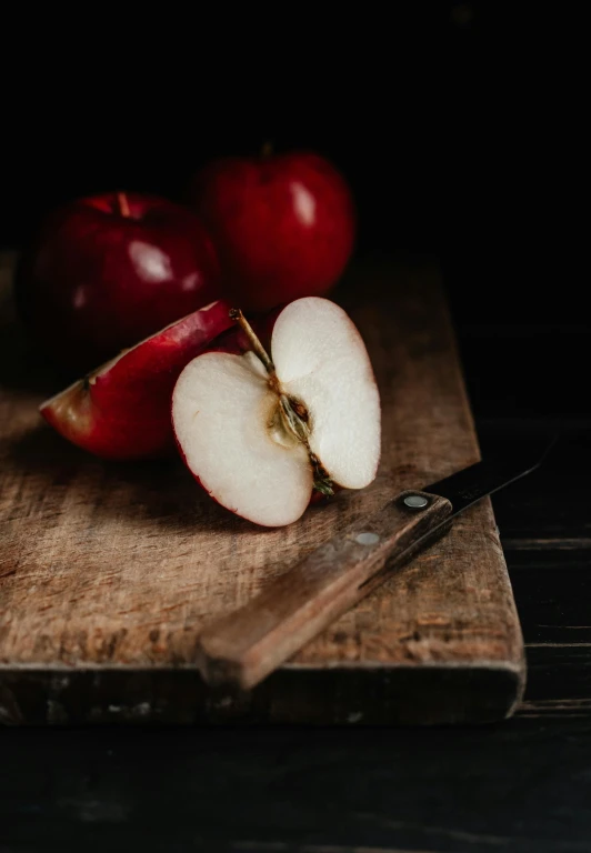 a wooden cutting board topped with sliced apples, a still life, pexels contest winner, renaissance, dark red, 15081959 21121991 01012000 4k, seductive expression, alessio albi