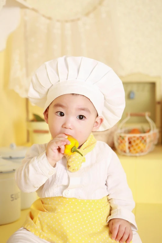 a baby in a chef's hat eating a banana, inspired by Li Di, pixabay contest winner, japanese model, thumbnail, high quality image, 1