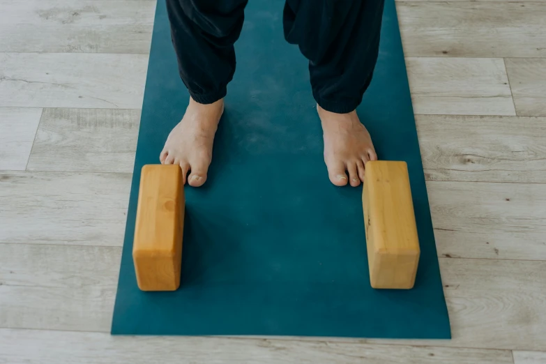 a person standing on top of a yoga mat, trending on pexels, figuration libre, wood blocks bottom hippo body, knees weak, front facing, rectangular