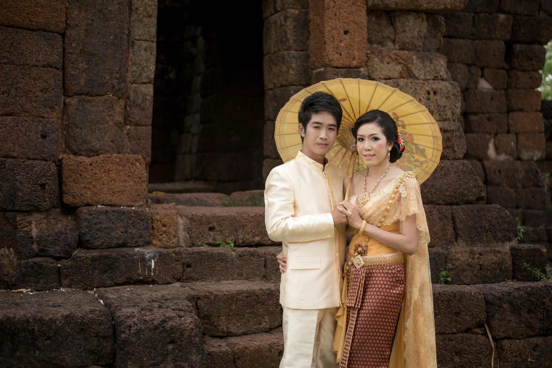 a man and a woman standing next to each other, a picture, inspired by Jin Nong, unsplash, sukhothai costume, portrait image, brown, square