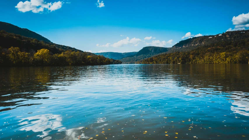 a body of water with trees and mountains in the background, by Julia Pishtar, pexels contest winner, hudson river school, looking over west virginia, blue sky, slide show, floathing underwater in a lake