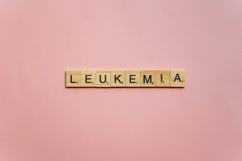 the word leukemia spelled with scrabbles on a pink background, an album cover, by Emma Andijewska, shutterstock, letterism, lumen technology, yume nikki, leica 1 0 0 mm f 0. 8, on a gray background