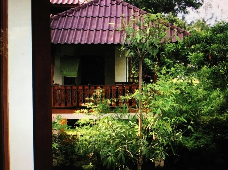 a house sitting in the middle of a lush green forest, a picture, thai, square, brown, balcony