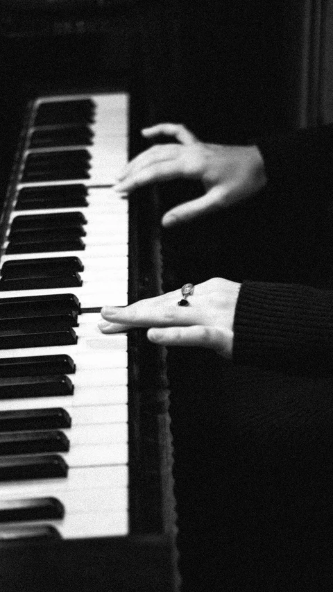 a black and white photo of a person playing a piano, inspired by Kawai Gyokudō, 15081959 21121991 01012000 4k, normal hands, [ realistic photo ]!!, keyboards