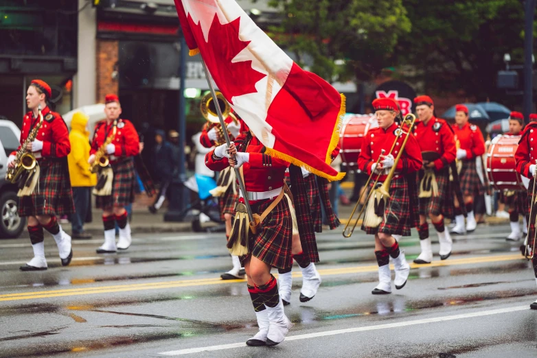 a group of men in kilts marching down a street, by Julia Pishtar, pexels contest winner, vancouver school, military flags, avatar image, image of ronald mcdonald, maple syrup sea