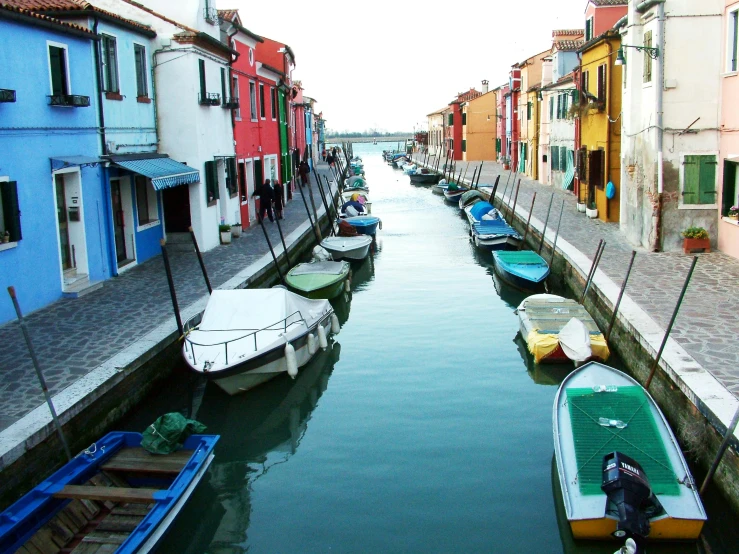 a number of small boats in a body of water, a photo, inspired by Quirizio di Giovanni da Murano, pexels contest winner, primary colors are white, village, 🦩🪐🐞👩🏻🦳, muted colours 8 k