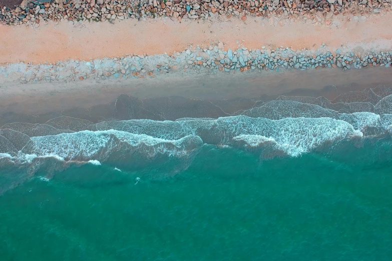 a large body of water next to a sandy beach, by Carey Morris, pexels contest winner, airborne view, pastel overflow, teal orange, ocean sprites