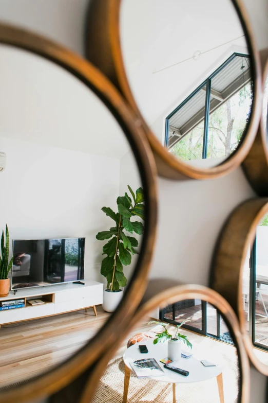 a living room filled with furniture and mirrors, unsplash contest winner, light and space, beachwood treehouse, close up details, tv frame, midcentury modern