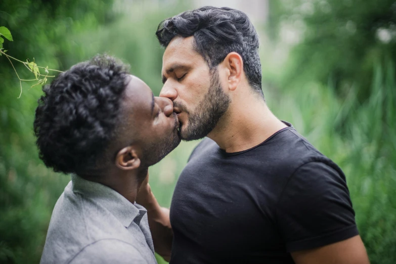 a couple of men standing next to each other, trending on unsplash, the kiss, varying ethnicities, square masculine jaw, sydney park