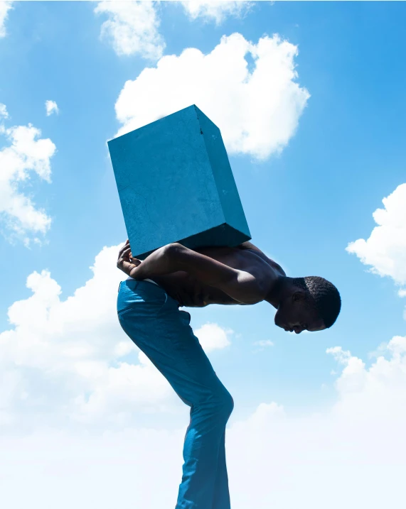 a man holding a blue box over his head, inspired by Scarlett Hooft Graafland, pexels contest winner, black teenage boy, ascending form the sky, head down, contemporary sculpture