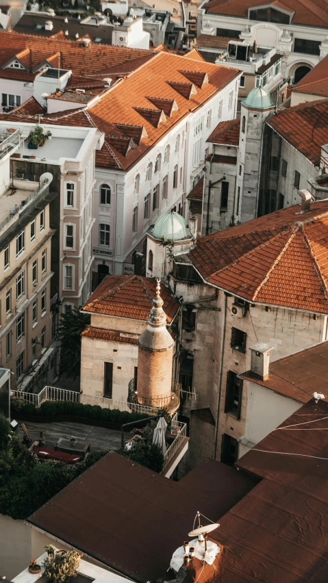 an aerial view of a city with a clock tower, by Matija Jama, pexels contest winner, art nouveau, rounded roof, split near the left, ivory and copper, al fresco