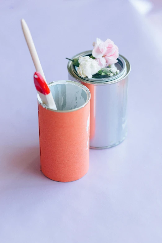 a close up of a cup with a toothbrush in it, a gouache, featured on pinterest, holding a tin can, coral, matte finish, recycled