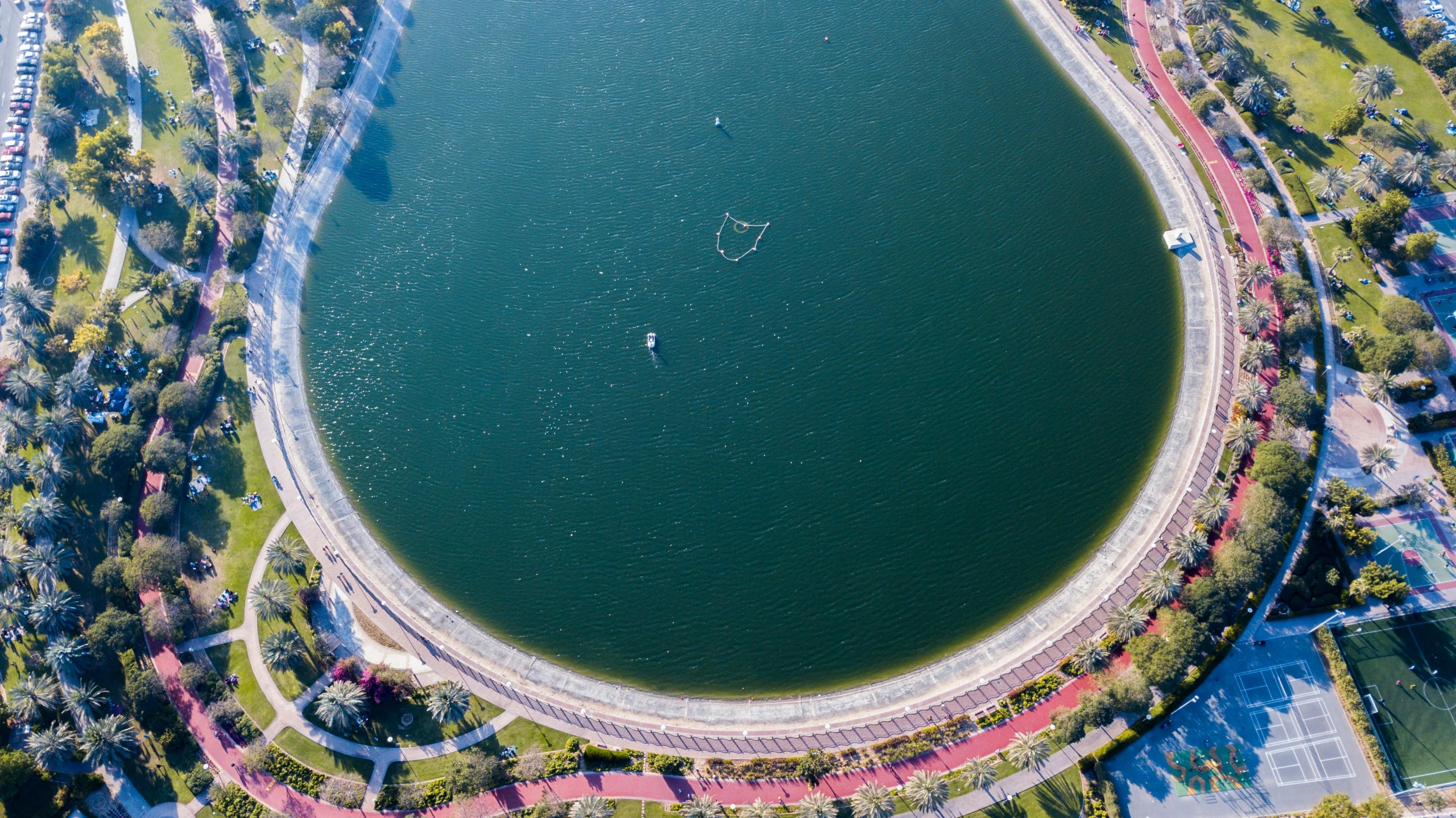 a large body of water surrounded by trees, by Niko Henrichon, pexels contest winner, hurufiyya, venus project, all enclosed in a circle, oscar niemeyer, water reservoir