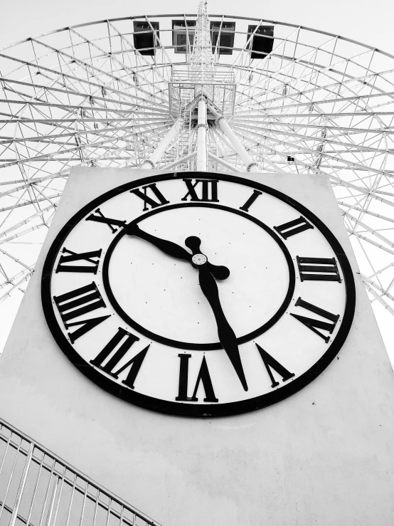 a clock tower with a ferris wheel in the background, by Joe Bowler, infared photography, good times photograph, foto