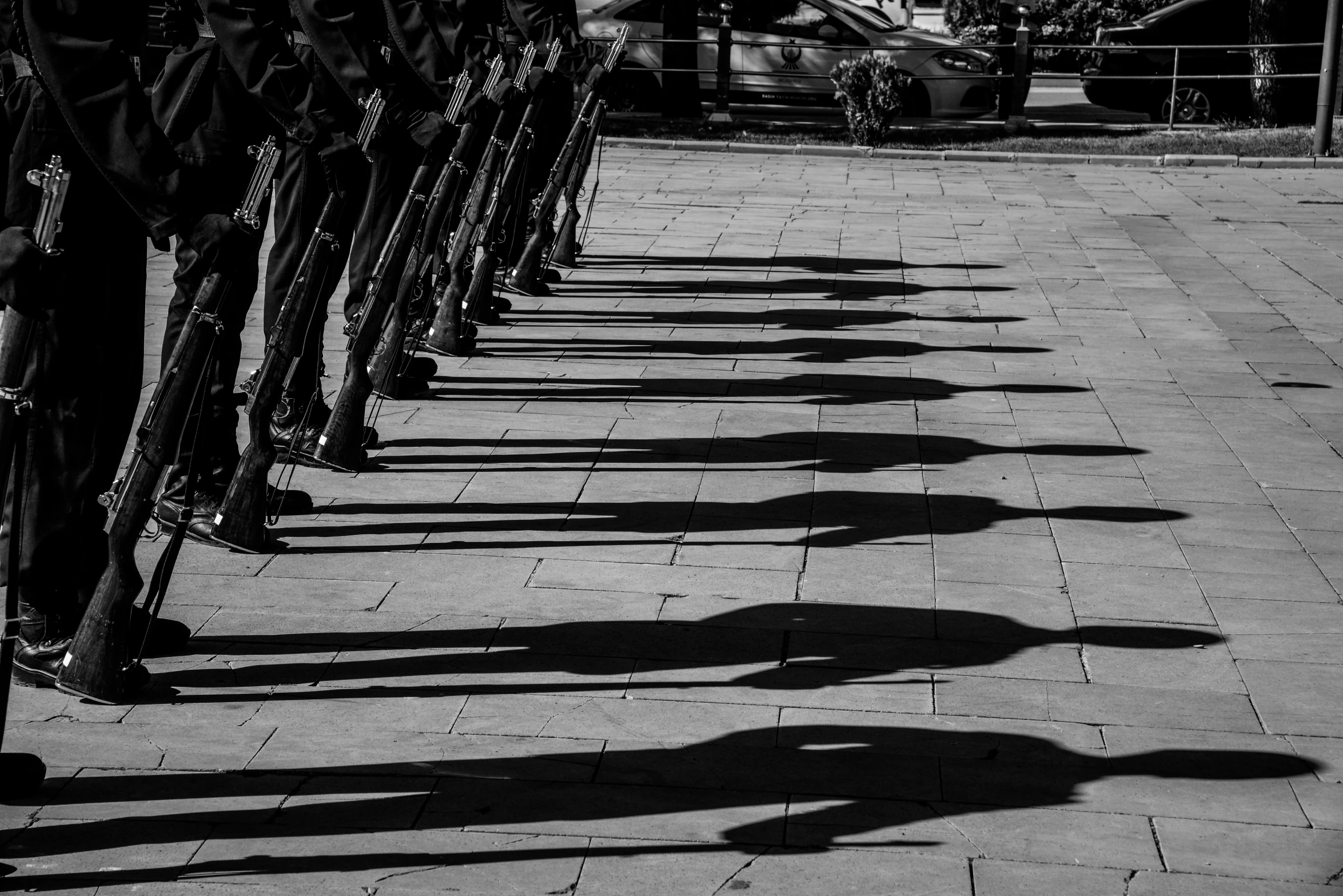 a black and white photo of a row of bicycles, by Kristian Kreković, pexels contest winner, wearing military shoes, shadow art, human shape, cavalry