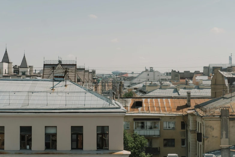 a view of a city from the top of a building, by Emma Andijewska, simple gable roofs, hasbulla magomedov, 000 — википедия, gray