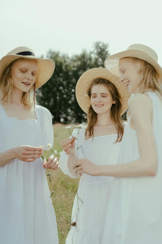 a group of women standing next to each other in a field, inspired by Elsa Beskow, renaissance, white hat, ignant, candid portrait photo, promotional image